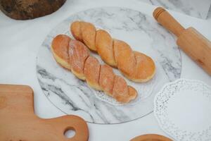frisch gebacken Croissants auf ein Marmor Tafel mit hölzern rollen Stift foto