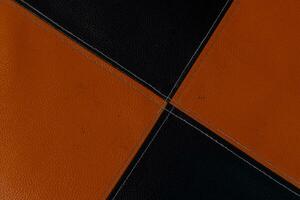 Sofa mit schwarz und Orange Schnitt Linien mittlere Kreuz machen das Farbe Aufteilung klar foto
