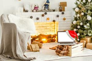 laptop mit geschenkbox und weihnachtsbeleuchtung hintergrund foto