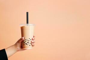 ein Hand halten wegbringen Plastik Tasse von köstlich vereist Blase Milch Tee und schwarz Perlen mit Kopieren Raum. ai generiert foto