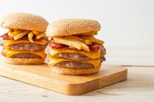 Schweinefleisch-Hamburger oder Schweinefleisch-Burger mit Käse, Speck und Pommes frites foto