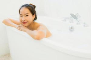 Porträt schöne junge asiatische Frau nimmt eine Badewanne im Badezimmer foto