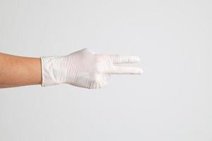 Hand mit medizinischen Handschuhen foto