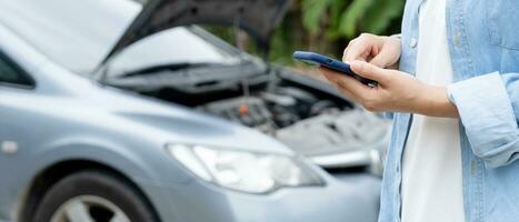 Panne, kaputtes Auto, Reparatur. frau nutzt handycheck-versicherungsprämien durch anwendung aufgrund eines autounfalls. Garage finden, um Auto während der Landtour reparieren zu lassen, auf Hilfe warten, Notfall. foto