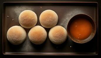 generativ ai, Mochi auf das dunkel Tabelle Hintergrund, traditionell japanisch Nachtisch, oben Sicht, eben legen foto