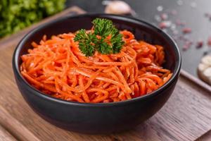 köstliche würzig saftige helle koreanische Karotten in Keramikgerichten foto