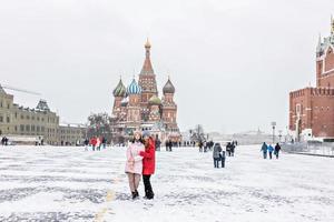 Ein schönes junges Mädchen geht während eines Schneefalls und eines Schneesturms auf dem Roten Platz in Moskau