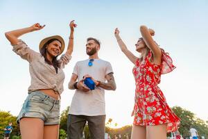 Unternehmen von freunde haben Spaß zusammen im Park Hören zu Musik- foto