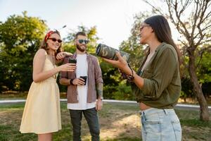 Unternehmen von freunde haben Spaß zusammen im Park Hören zu Musik- foto