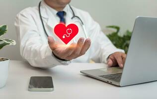 ein Arzt halten und zeigen ein rot Herz beim Krankenhaus Büro. medizinisch Gesundheit Pflege und Arzt Mitarbeiter Bedienung Konzept. foto