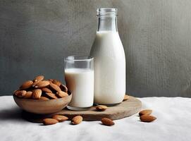 organisch Mandel Milch im Glas Flasche in der Nähe von Keramik Schüssel mit roh Mandeln auf Stein Tabelle im das Küche bereit zum Kochen. erstellt mit generativ ai Technologie. foto