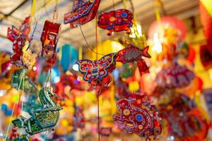 dekoriert bunt Laternen hängend auf ein Stand im das Straßen im ho Chi minh Stadt, Vietnam während Mitte Herbst Festival. Chinesisch Sprache im Fotos bedeuten Geld und Glück. selektiv Fokus.