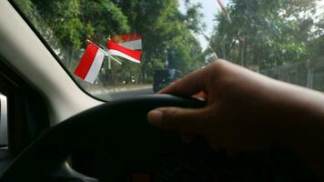 das indonesisch Flagge ist montiert auf das Windschutzscheibe von das Auto zu herzlich willkommen Indonesiens Unabhängigkeit Tag foto