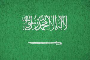 Saudi Arabien Flagge abgebildet im hell Farbe Farben auf alt Linderung Verputzen Mauer. texturiert Banner auf Rau Hintergrund foto