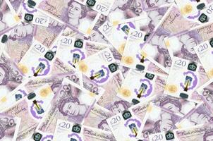 20 britische Pfund-Scheine liegen in einem großen Haufen. konzeptioneller hintergrund des reichen lebens foto