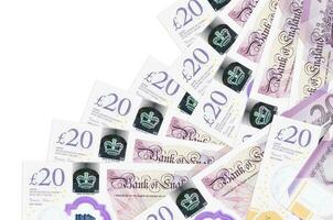 20 britische Pfund-Scheine liegen in unterschiedlicher Reihenfolge isoliert auf Weiß. Konzept für lokales Bankwesen oder Geldverdienen foto