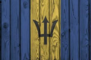 Barbados Flagge abgebildet im hell Farbe Farben auf alt hölzern Mauer. texturiert Banner auf Rau Hintergrund foto