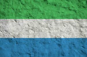 sierra leone flagge in hellen farben auf alter reliefputzwand dargestellt. strukturierte Fahne auf rauem Hintergrund foto