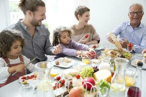 glücklich verlängert Familie haben Mittagessen beim Zuhause foto