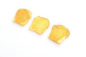 gebackenes knuspriges Brot mit Butter und Zucker isoliert auf weißem Hintergrund foto