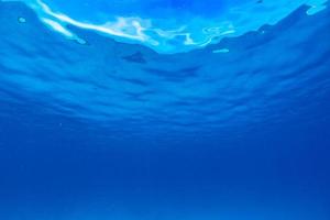 Unterwasser tropischer Sonnenstrahlen, die durch Wasser gehen. foto