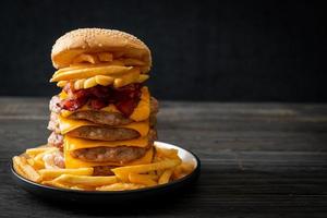 Schweinefleisch-Hamburger oder Schweinefleisch-Burger mit Käse, Speck und Pommes frites foto