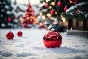 rot Weihnachten Ball Ornament auf das Schnee mit Weihnachten Baum und Beleuchtung foto