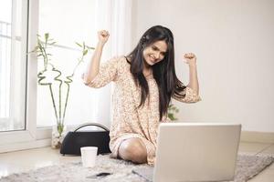 verlassene junge indische frau mit laptop zu hause. foto