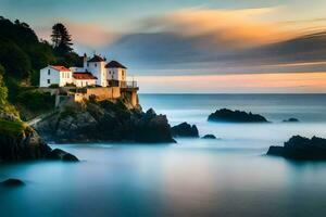 ein Weiß Haus sitzt auf ein felsig Cliff mit Blick auf das Ozean. KI-generiert foto