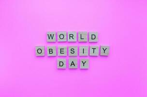 Oktober 11, Welt Fettleibigkeit Tag, minimalistisch Banner mit das Inschrift im hölzern Briefe foto