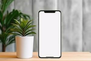 Smartphone Attrappe, Lehrmodell, Simulation mit leer Bildschirm und saftig Pflanze auf hölzern Tabelle ai generiert foto