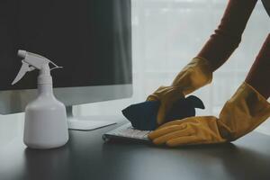 Büro Reinigung Service. Hausmeister Sprühen Schreibtisch. Arbeitsplatz Hygiene foto