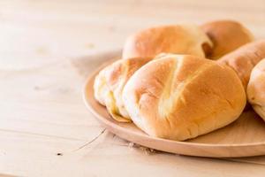 Brot in Holzplatte auf weißem Hintergrund foto