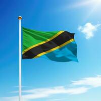 winken Flagge von Tansania auf Fahnenstange mit Himmel Hintergrund. foto