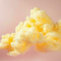 ein Baumwolle Süßigkeiten Gelb Hintergrund mit flauschige Wolken foto