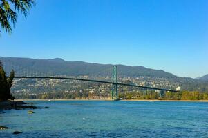 entdecken das grenzenlos Pracht von das Löwen Tor Brücke im Vancouver, britisch Columbia, wie das schön Brücke Kreuze das Ozean Wasserweg unter Blau Himmel. foto