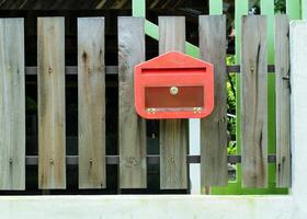 Briefkasten rote Farbe auf dem Holzzaun foto