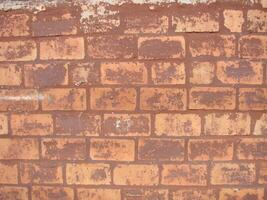 Red Brick Wall Textur Grunge-Hintergrund mit vignettierten Ecken, kann für die Innenarchitektur verwendet werden foto