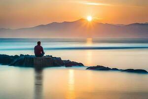 ein Mann Sitzung auf Felsen beim das Strand beim Sonnenuntergang. KI-generiert foto