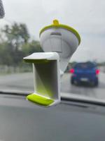 weißer grüner leerer Smartphone-Halter steckt in der Windschutzscheibe eines Autos foto