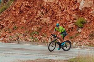 voll Länge Porträt von ein aktiv Triathlet im Sportbekleidung und mit ein schützend Helm Reiten ein Fahrrad. selektiv Fokus foto