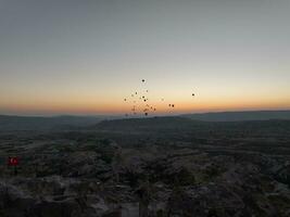 Antenne filmisch Drohne Aussicht von bunt heiß Luft Ballon fliegend Über Kappadokien foto