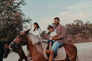 Die Familie verbringt Zeit mit ihren Kindern beim gemeinsamen Reiten an einem Sandstrand. selektiver Fokus foto