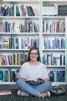 Famale Student Lesebuch in der Bibliothek foto