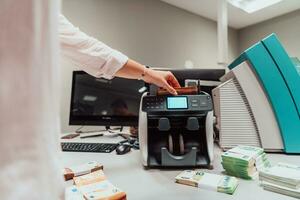 Bank Angestellte mit Geld Zählen Maschine während Sortierung und Zählen Papier Banknoten Innerhalb Bank Gewölbe. groß Beträge von Geld im das Bank foto