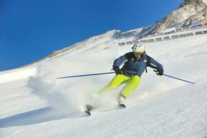 Skifahren auf Neuschnee in der Wintersaison am schönen sonnigen Tag foto