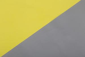 leuchtender gelber und ultimativer grauer Pastellpapierbeschaffenheitshintergrund foto