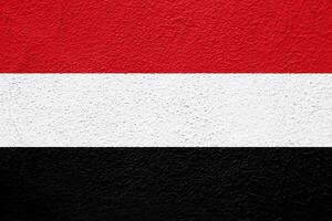 Flagge von Republik von Jemen auf ein texturiert Hintergrund. Konzept Collage. foto