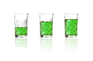 grüner Schnaps in Schnapsglas auf weißem Hintergrund, Absinth foto