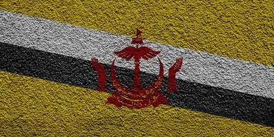 Flagge von brunei Darussalam auf ein texturiert Hintergrund. Konzept Collage. foto